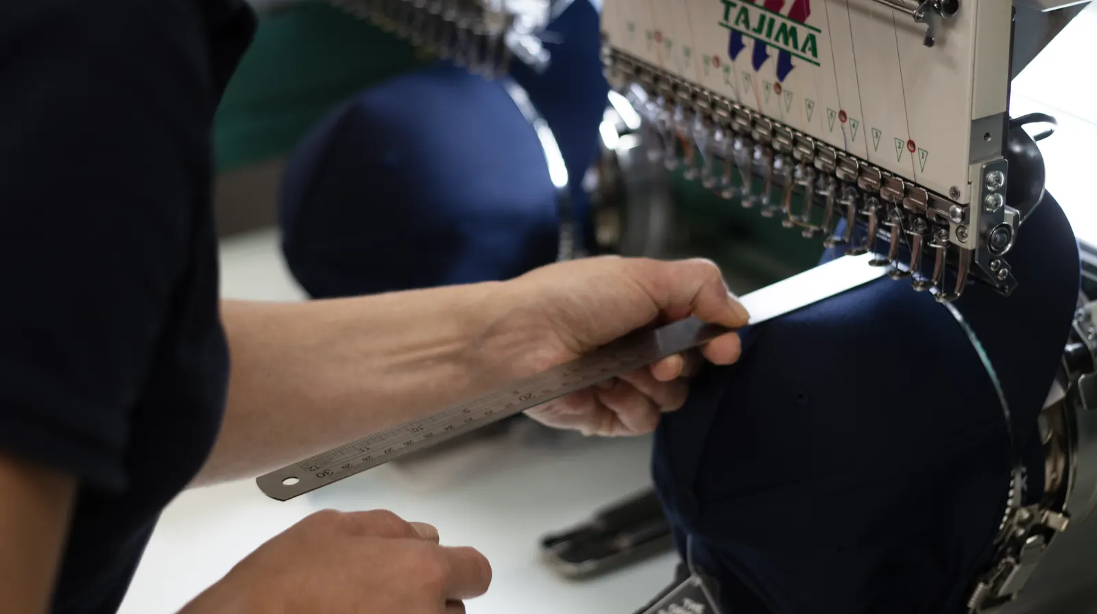 Cap fitted to the embroidery frame at BR Apparel before a branded run