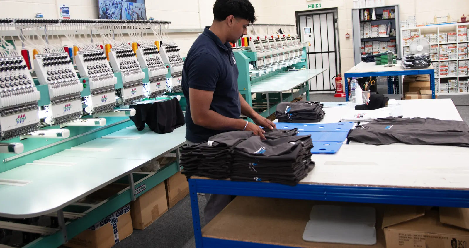 Branded garments folded and stacked for dispatch at BR Apparel, Bradford