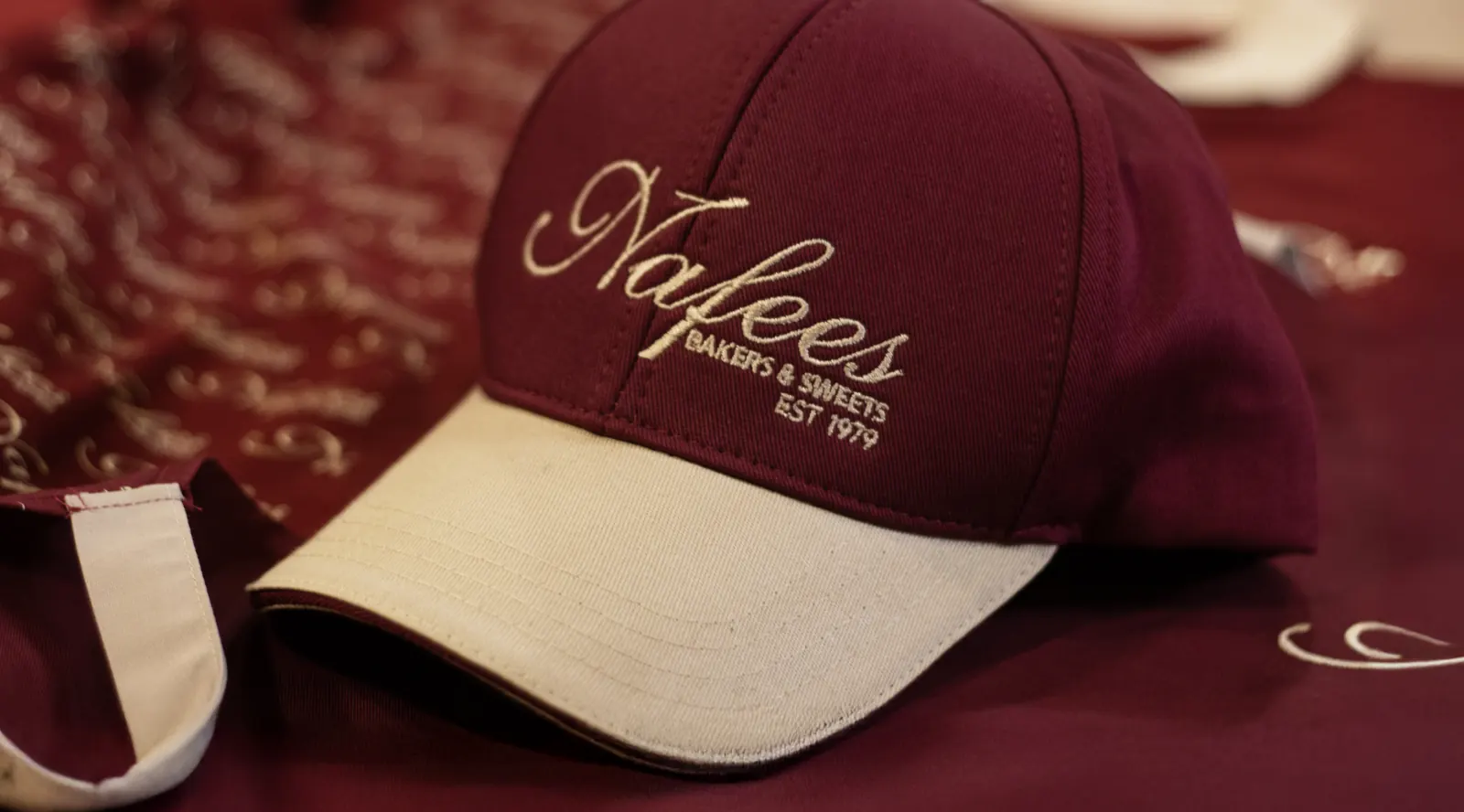 Embroidered cap and branded hospitality uniform detail
