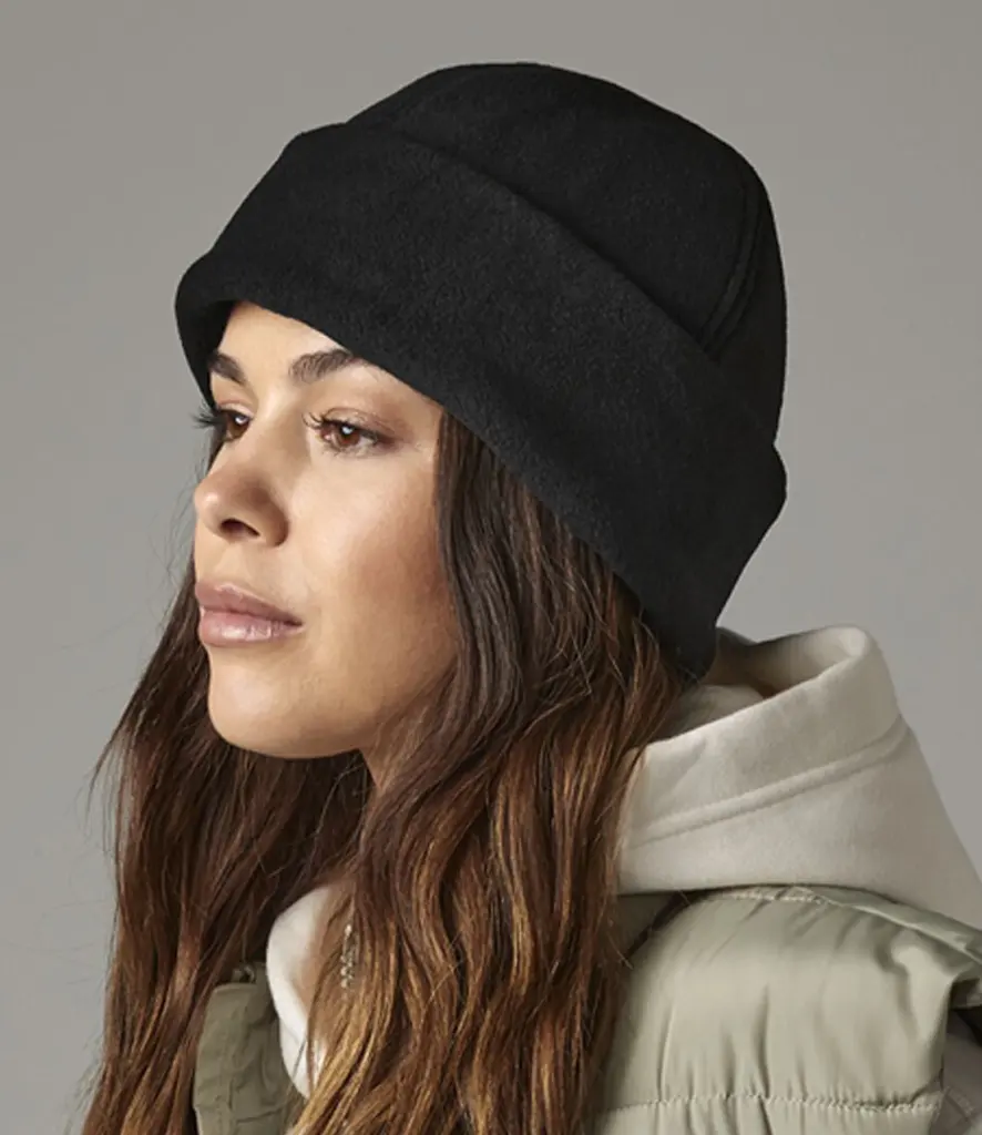 Model wearing a plain black cuffed beanie