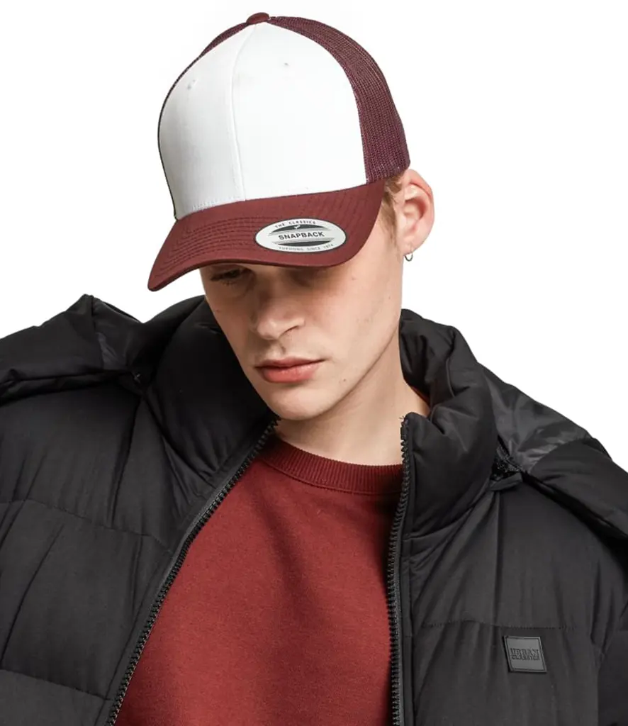 Model wearing a two tone trucker cap with a white front panel and a maroon mesh back
