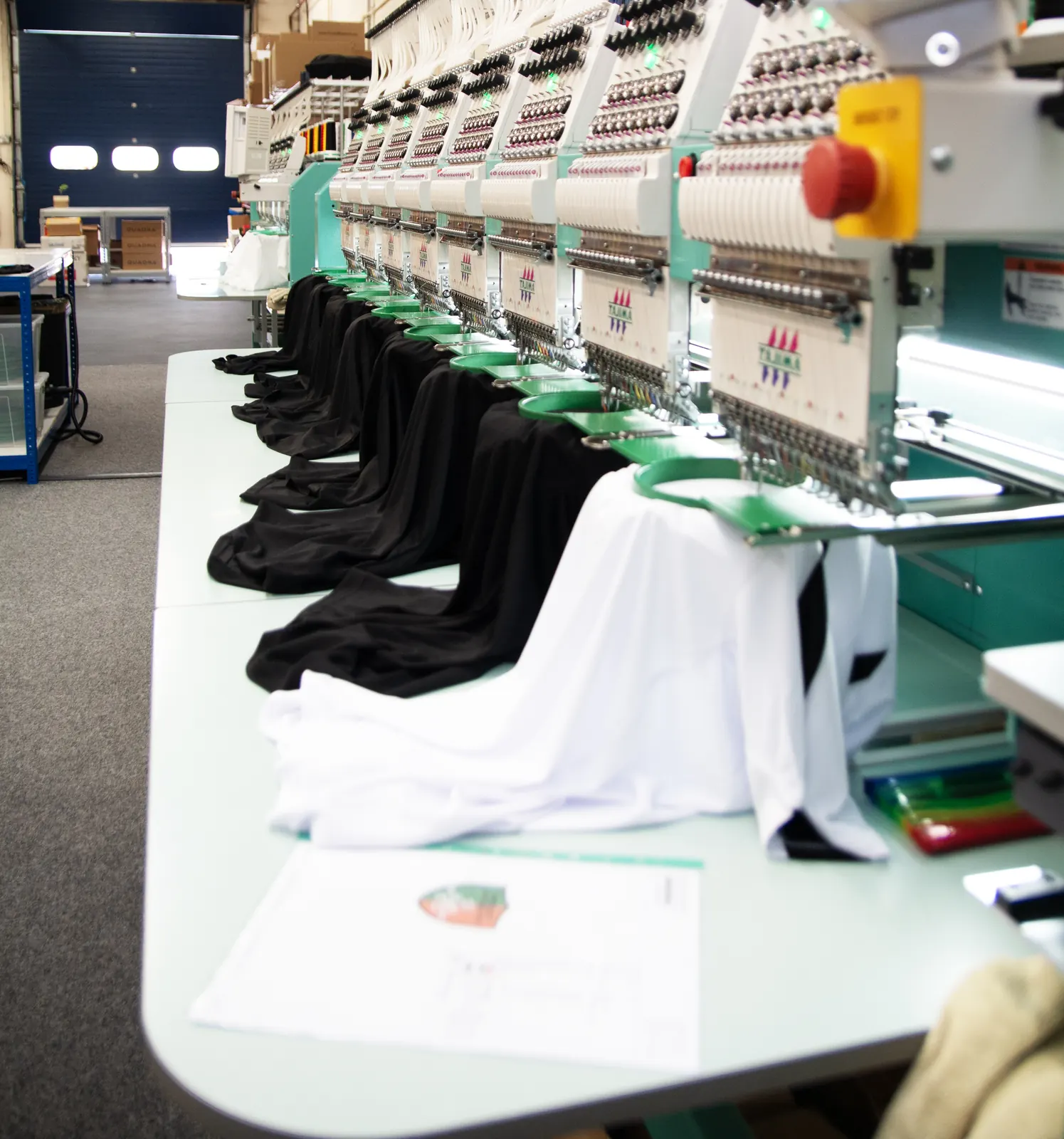 Embroidery machine line running branded garments at BR Apparel for Huddersfield customers