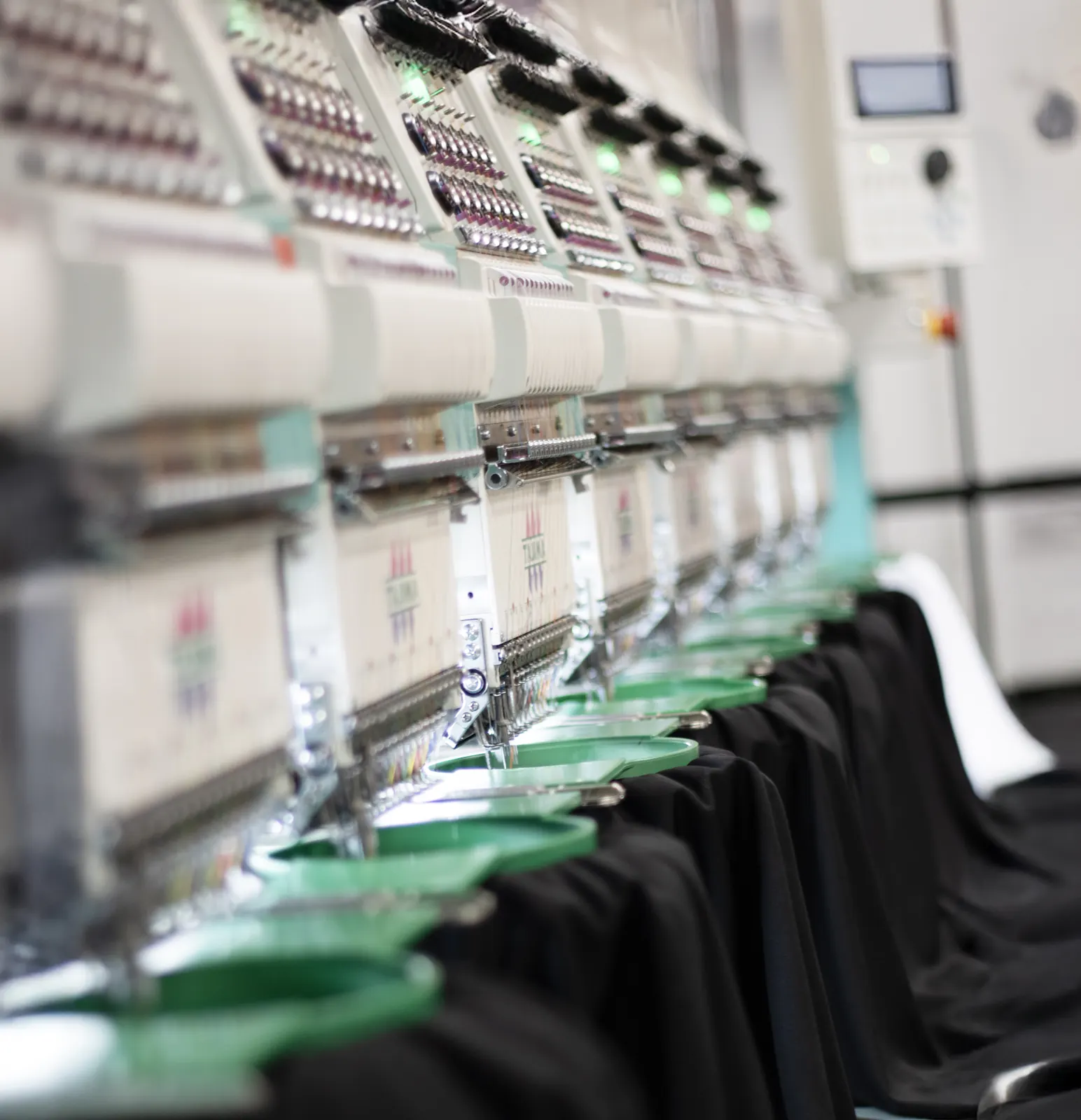 Multi-head embroidery machines running a batch of branded workwear at BR Apparel in Bradford