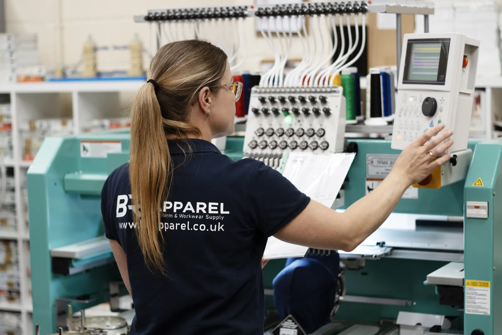 BR Apparel machine operator setting up an embroidery run for a Halifax order