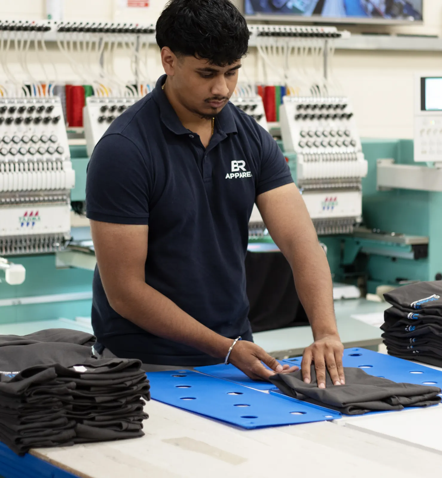 Navy workwear batch prepared for embroidery at BR Apparel in Bradford