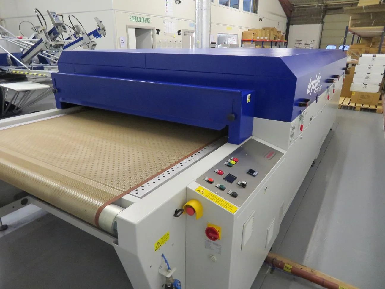 Conveyor dryer curing screen printed garments after the print run