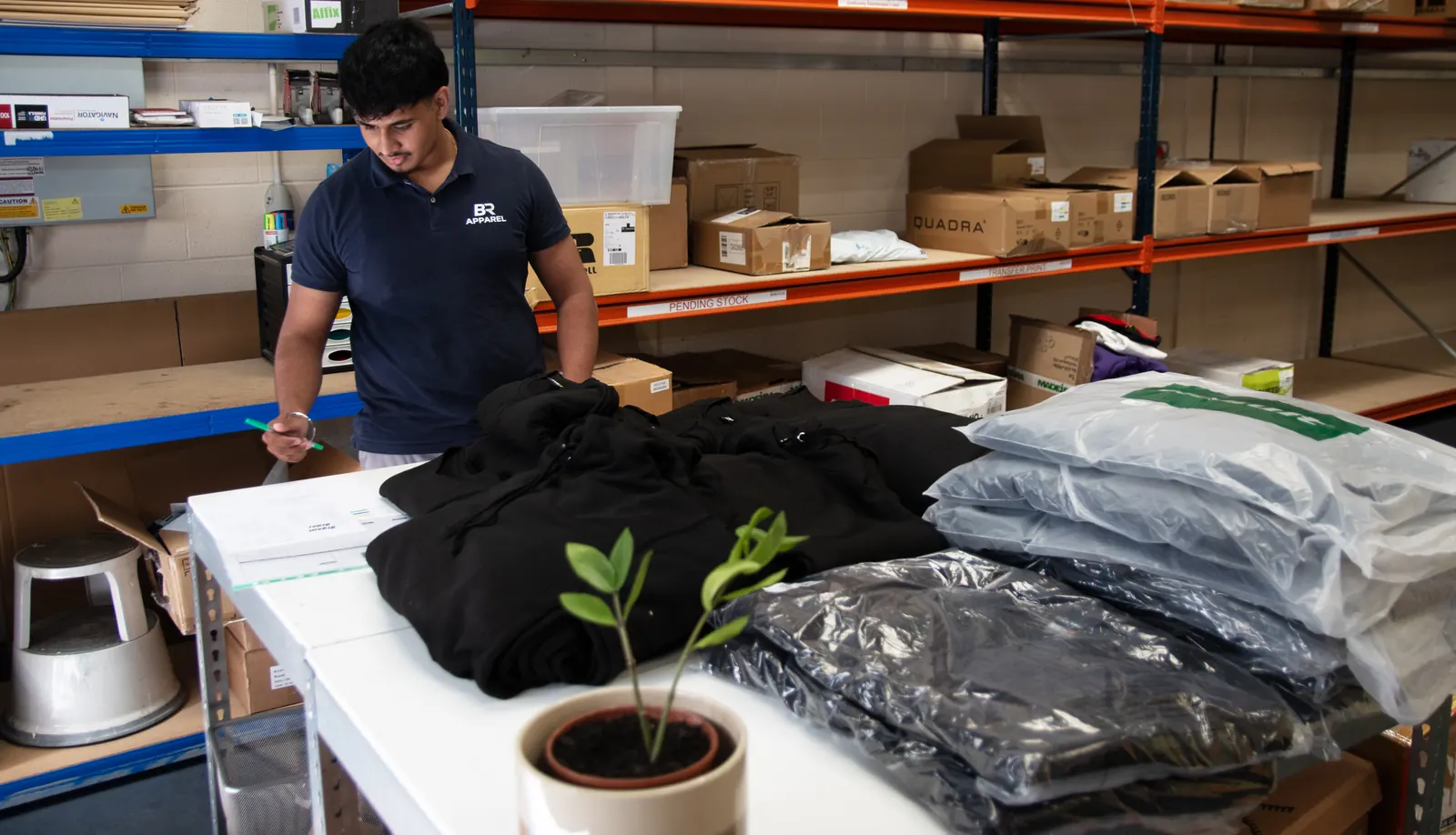 BR Apparel staff preparing workwear stock in the Bradford warehouse